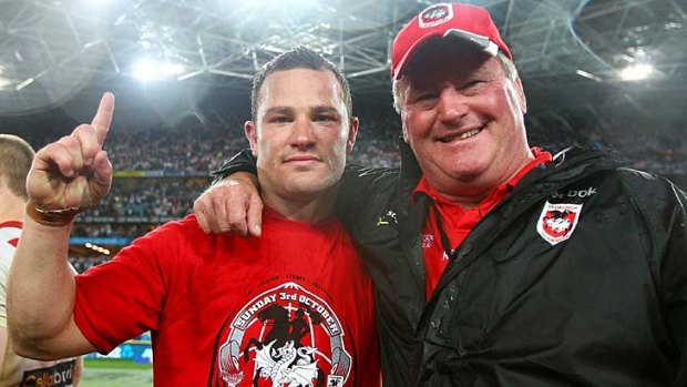Victorious ...  Dean Young celebrates with father Craig after his the Dragons' grand final glory.