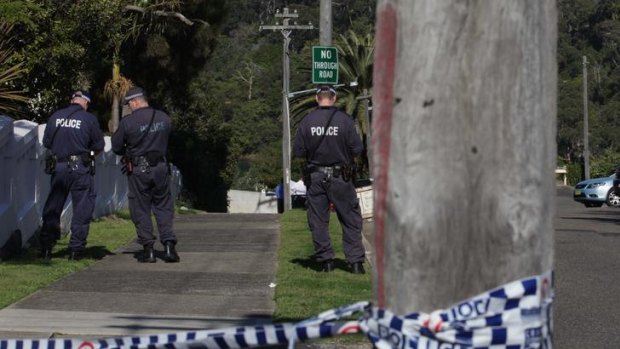 The morning after ... police search along Burrawong Avenue in Mosman.