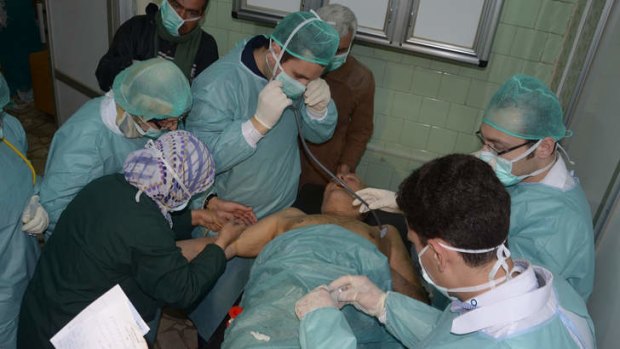 Breaking point: Doctors respond to the victim of an attack at a hospital in Aleppo, Syria.
