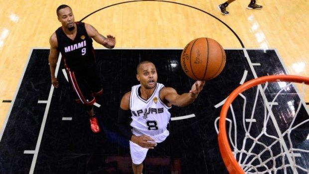 Patty Mills of the San Antonio Spurs goes to the basket against the Miami Heat during Game Two of the 2014 NBA Finals at the AT&T Center.