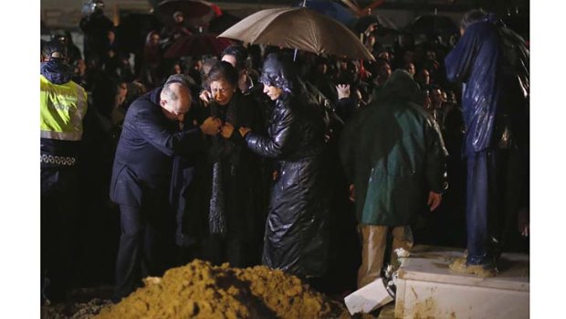 Flora (centre), the widow of Eusebio, breaks down during his funeral at Lumiar cemetery in Lisbon on Monday.