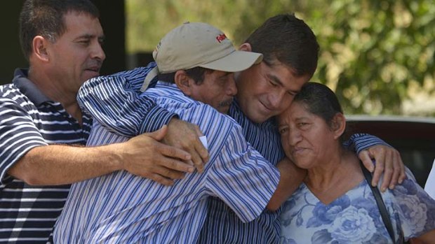 Happy families: Jose Salvador Alvarenga, second right,  hugs his mother and father.