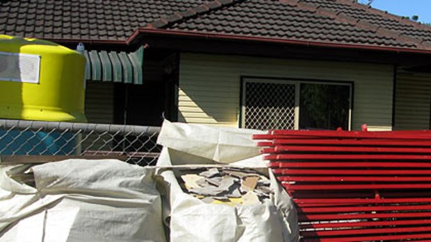 Asbestos stacked in front of a Rocklea house.