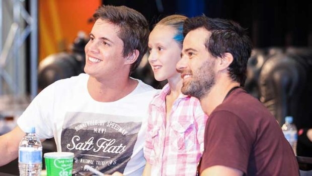 Johnny Ruffo and Charlie Clausen pose for a photo with a young admirer.
