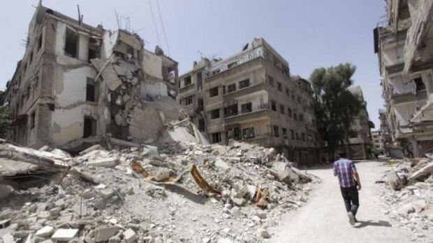 A man walks past destroyed buildings in the Ain Tarma neighbourhood of Damascus, Syria's capital.