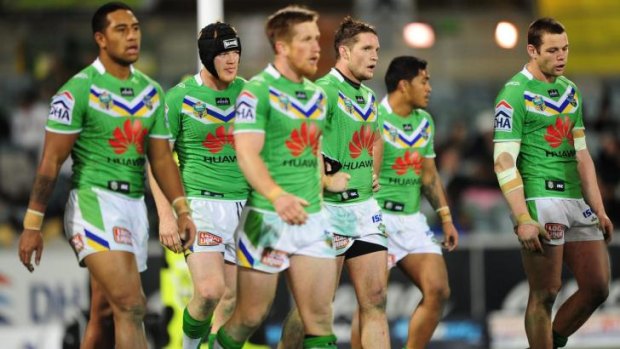 Dejected  Raiders players contemplate their 34-18 loss to the Rabbitohs  on Monday night.