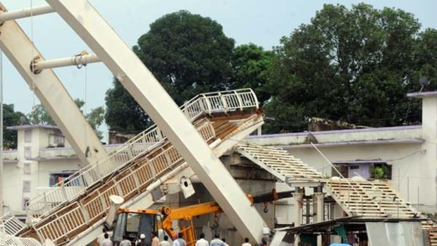 Indian workers gather after a footbridge collapsed at the Jawaharlal Stadium.