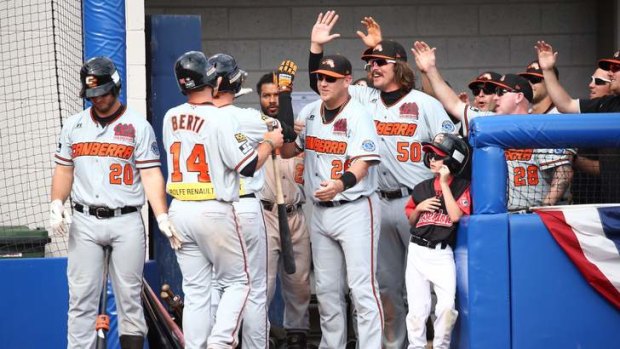 Canberra Cavalry players celebrate their remarkable 18-13 win over the Melbourne Aces.