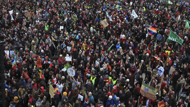 Activists gather near the Eiffel Tower on the final day of the Paris conference.