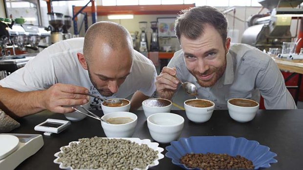 Barista champion Caleb Podhaczky and judge Ben Bicknell test Guatemala coffee beans, which will be featured at the temporary 'coffee farm' at Queensbridge Square.