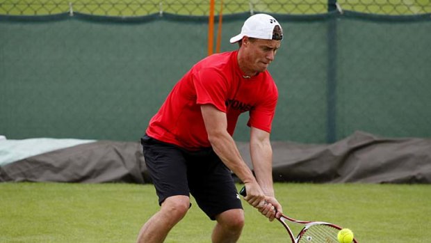 Playing tough: Defying a foot injury that put him out of his previous tournament, Lleyton Hewitt practises hard at Wimbledon.