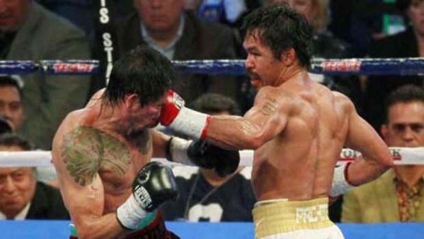 Still rising: Manny Pacquiao (right) and Antonio Margarito in action.