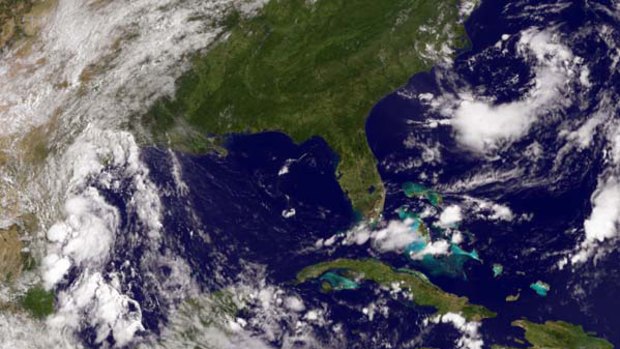 National Oceanic and Atmospheric Administration (NOAA) GOES satellite image shows a tropical depression (left) in the Gulf of Mexico.