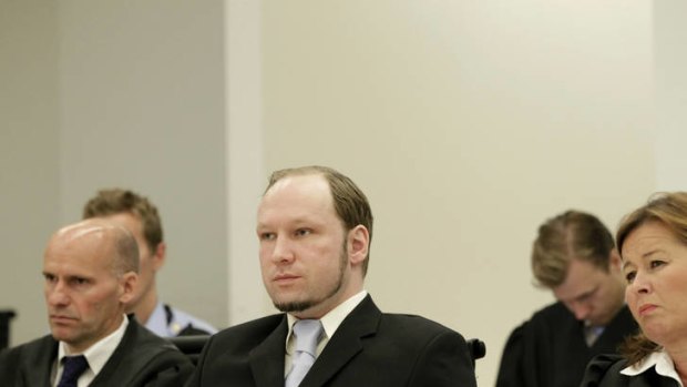 Killer Anders Behring Breivik (right) sit in court with his defence lawyer.