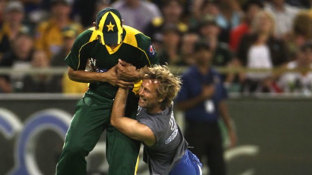 David Fraser tackles Pakistani player Khalid Latif after running onto the WACA last month.
