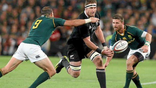 Man of the match Kieran Read slips a pass away for the All Blacks.