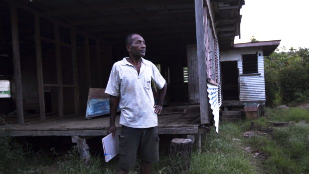 Sailosi Ramatu in his former village, where high tides buckled and warped the floors of this house.