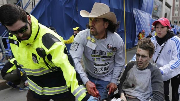 Acted out of instinct: Carlos Arredondo helps Jeff Bauman after the blasts.