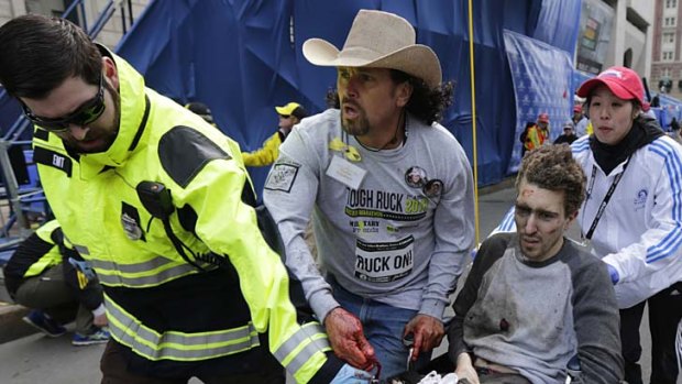 Jeff Bauman is rushed from the scene by Carlos Arredondo and other rescue workers