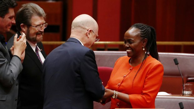 Senator Lucy Gichuhi is congratulated by LDP senator David Leyonhjelm after delivering her maiden speech in the Senate.