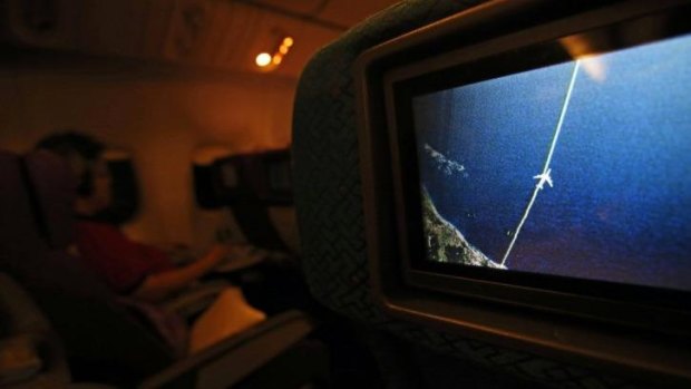 A screen on board a Malaysia Airlines Boeing 777-200ER shows the plane's flight path as it cruises over  the South China Sea from Kuala Lumpur towards Beijing.