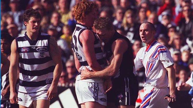 If I go, you go... Nathan Buckley and Cameron Ling skirmish.