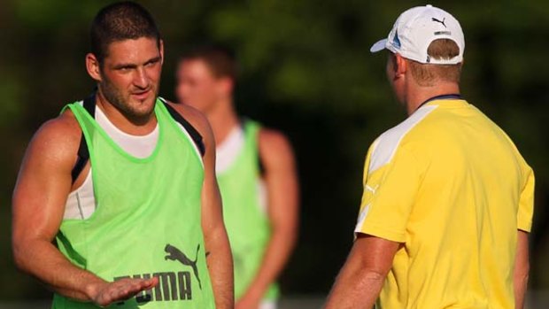 Brendan Fevola chats with coach Michael Voss during a Brisbane Lions training session.