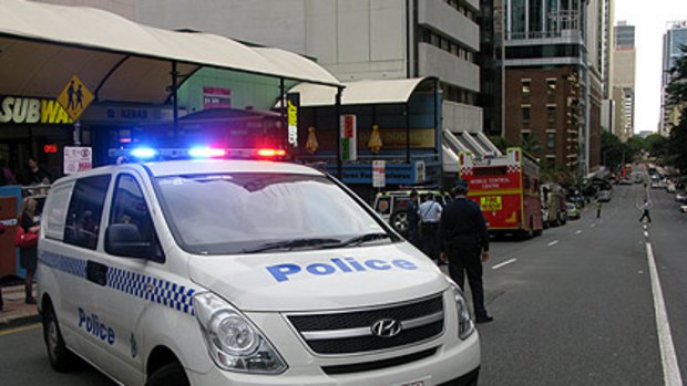Police close down Adelaide Street after a suspicious package was delivered to a building housing the Department of Immigration and Citizenship offices.