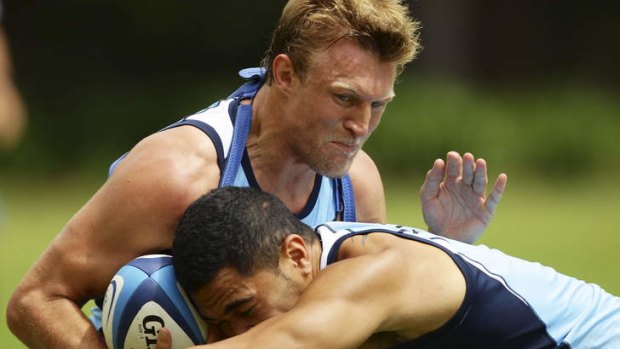 SYDNEY, AUSTRALIA - FEBRUARY 06: Lachie Turner takes on the defence during a Waratahs Super Rugby training. (Photo by Matt King/Getty Images)    James Polson  Page Editor, Sport and Racing, The Sydney Morning Herald/The Sun Herald  Ph: 0422-336-318     lachie.jpg