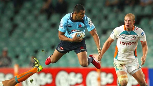 Free falling . . .  Kurtley Beale of the Waratahs is tackled.