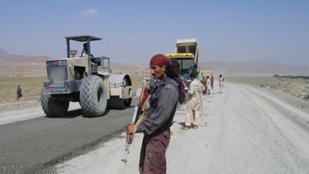 Arms at the ready as construction occurs on Afghanistan's roads.