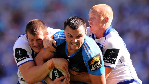 Beau Champion of the Titans is tackled during the round five NRL match between the Gold Coast Titans and the Canterbury Bulldogs