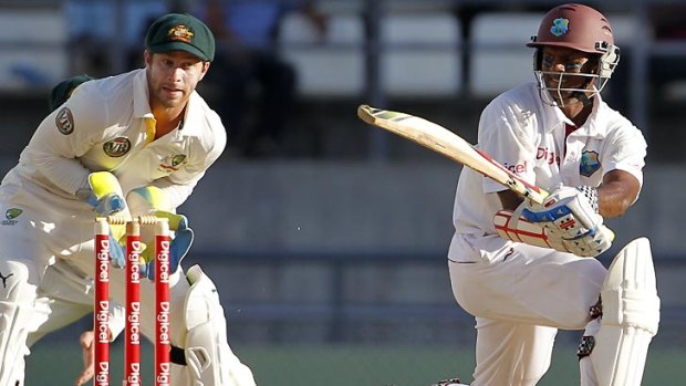 Australia's wicket keeper Matthew Wade looks on as West Indies' Shivnarine Chanderpaul, right, plays a sweep.