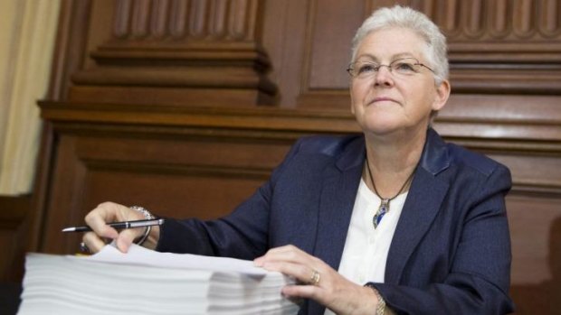 Environmental Protection Agency (EPA) Administrator Gina McCarthy looks up after signing new emission guidelines.