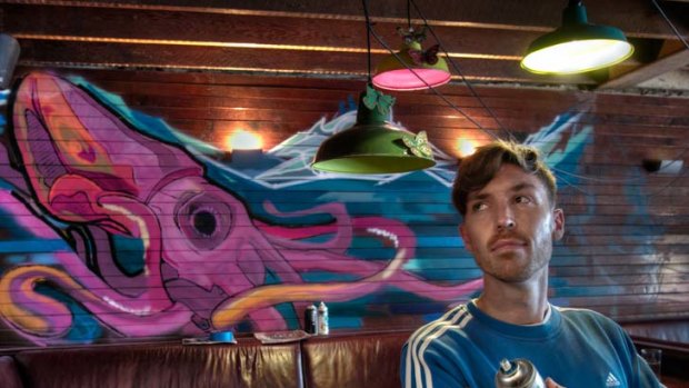 Street artist Richard Wolter makes a squid on the side at Richmond's Holliava wine bar, in Swan Street. Some places, such as churches, are off limits, he says.