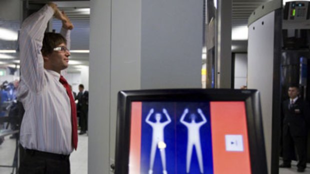 Just like this...a Dutch employee demonstrates the security body scanner body scanner to be used on passengers at Australian's eith international airports.