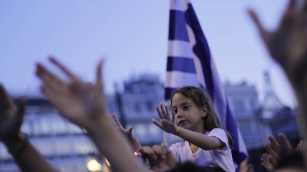 Demonstrators gesture at the Greek Parliament in a peaceful rally in central Athens. Thousands have gathered for a 25th consecutive day to protest austerity measures.