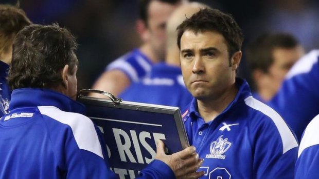 North Melbourne coach Brad Scott does not look particularly happy at three-quarter-time.