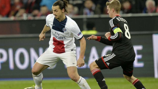 Leverkusen's Lars Bender closes in on PSG's Zlatan Ibrahimovic.
