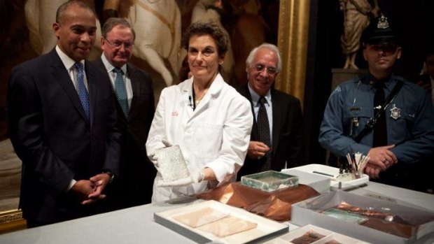 L-R: Massachusetts governor Deval Patrick, Malcolm Rogers, director of the Museum of Fine Arts, Boston, Pam Hatchfield, head of objects conservation at the Museum of Fine Arts, Boston, and B.J. Mohammadipour display a silver plaque inscribed by Paul Revere, after the unveiling of the contents of a 1795 time capsule, at the Museum of Fine Arts.