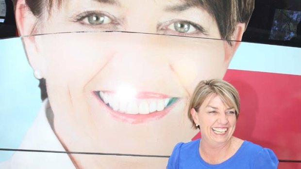 In the driver's seat ... Queensland Premier Anna Bligh next to her campaign bus in Rockhampton.