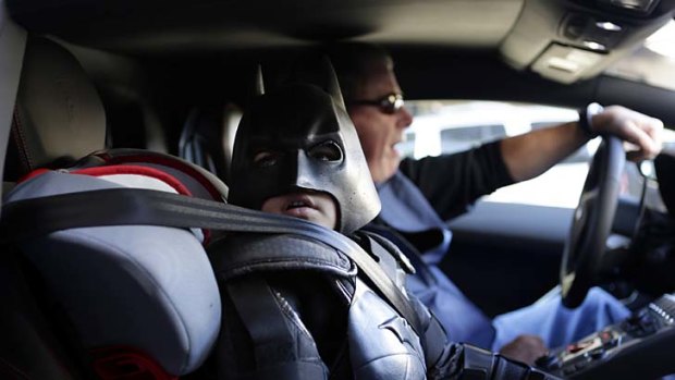 Miles Scott, 5, dressed as Batkid, waits in a Lamborghini "Batmobile" as he and Batman get ready to stop a bank robbery in San Francisco.