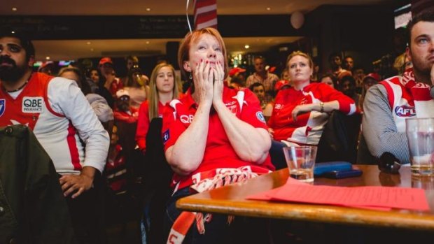 Not our day: Swans supporters at the Rising Sun Hotel in South Melbourne feel the crushing weight of imminent defeat.