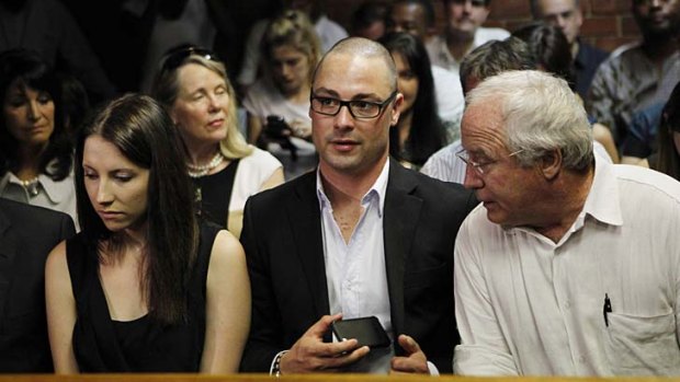 Pistorius' sister Aimee, brother Carl and father Henke await the start of court proceedings.