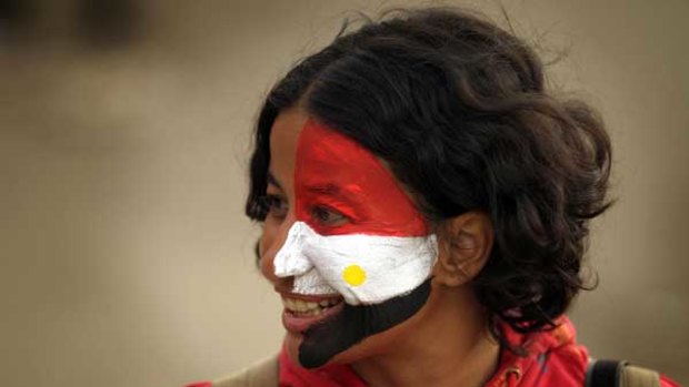 Thousands of anti-government protesters, many with faces painted in the colours of the Egyptian flag, assembled peacefully at Tahrir Square, Cairo.