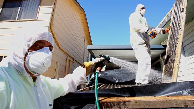 Fighting the good fight ... John Limpus and his team remove asbestos from a house in Lake Haven.