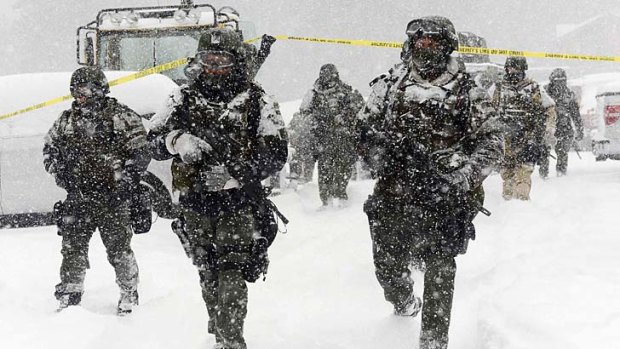 Declared war &#8230; A SWAT team returns to a command post at Big Bear Mountain on Friday.