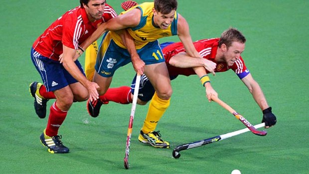 Middle man &#8230; Australia's Eddie Ockenden is tackled by England's Adam Dixon and Barry Middleton in the Champion's Trophy quarter-final on Thursday night.