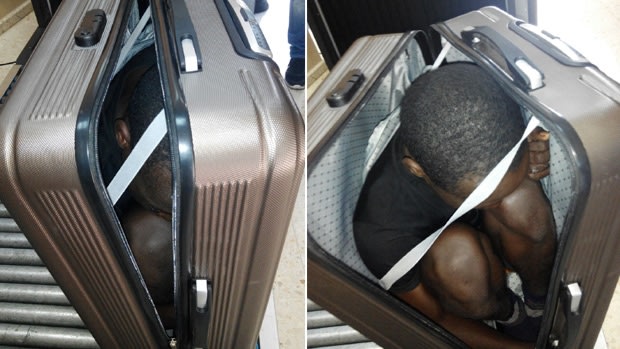 A 19 year-old migrant from Gabon is photographed in a suitcase, in Ceuta, Spain. 
