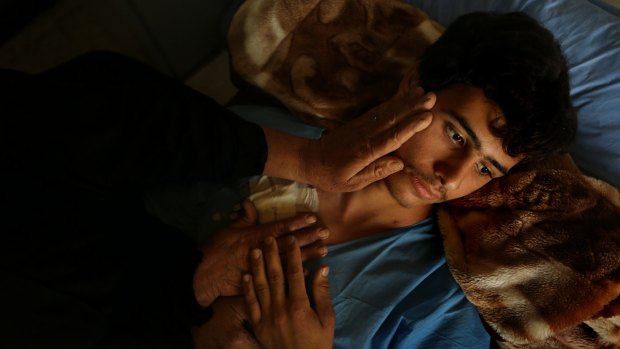 Ismail Abdul Hassan, 17, recovers in al-Wasiti Hospital in Baghdad from injuries caused by an IED blast.